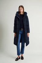 A model wearing the Woolrich Madison Long Coat Melton Blue Coat, showcasing its stylish and functional design.