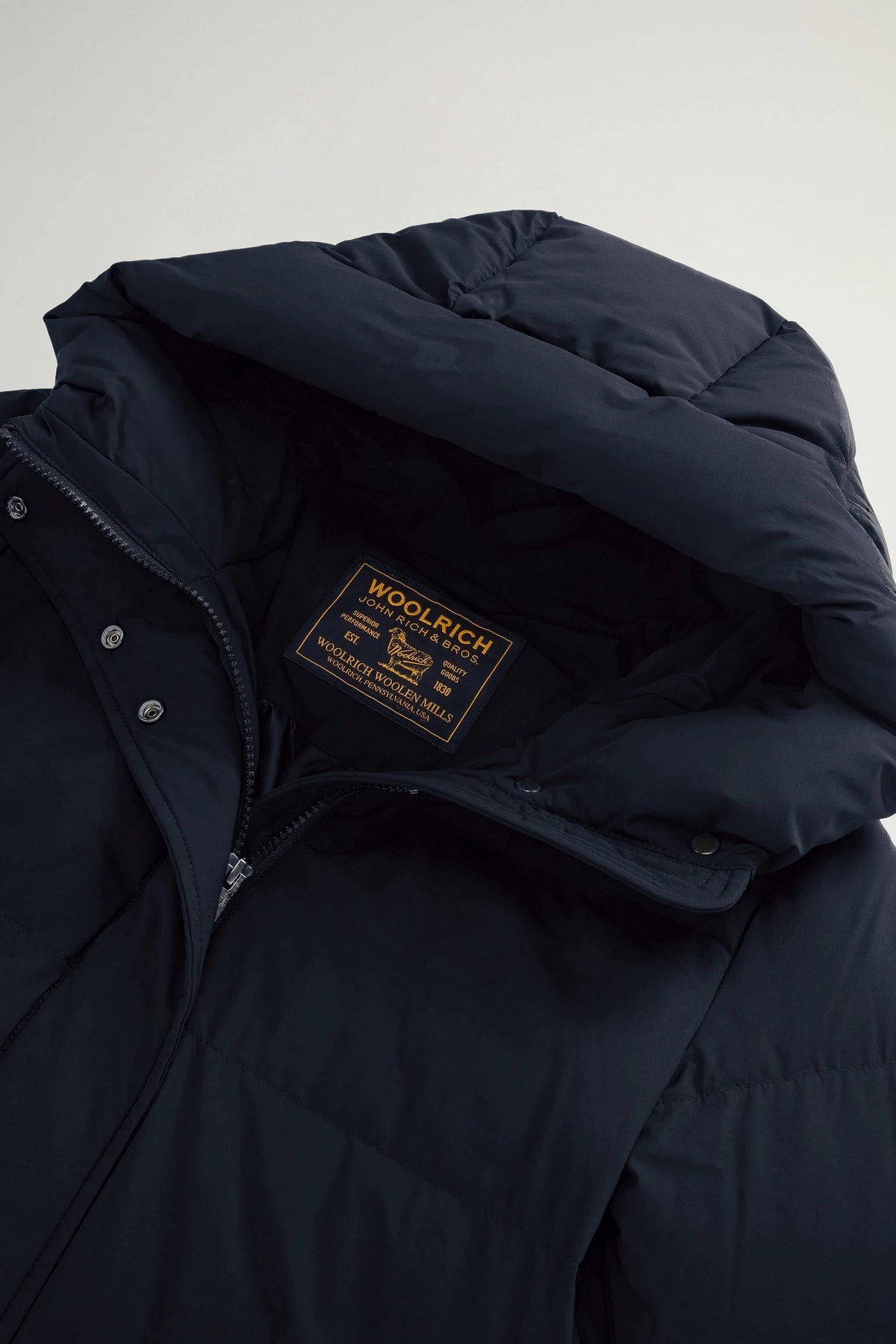 Madison Long Coat Melton Blue Coat by Woolrich, featuring a premium down fill and a stand-up collar.