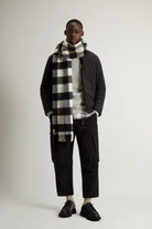 Model wearing a Cloud Lewis Bomber Black Coat with a stylish checkered scarf and casual trousers.
