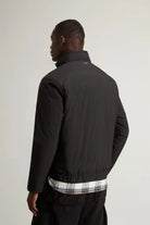 Back view of a man wearing the Cloud Lewis Bomber Black Coat, showcasing its sleek design and stand-up collar.