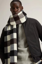 Model wearing a Cloud Lewis Bomber Black Coat with a stylish checkered scarf.