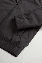 Cloud Lewis Bomber Black Coat close-up view featuring sleeve and zipper detail.