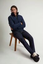 Model wearing Cloud Lewis Bomber Melton Blue Coat sitting on a chair, showcasing its stylish design and fit.