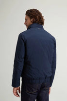 Man wearing Cloud Lewis Bomber Melton Blue Coat, showcasing the back view with a stand-up collar in navy.