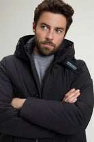 Stretch Parka Black Coat worn by a model, showcasing its premium design and adjustable features.