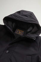 Close-up of the Stretch Parka Black Coat hood and collar with Woolrich tag, showcasing premium light stretch fabric.
