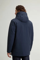 Back view of a man wearing a Stretch Parka Melton Blue Coat with a hood, showcasing the premium design and fit.