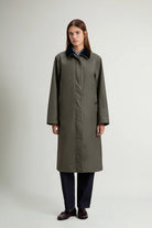 Waxed Coat Waxed Dark Green Coat displayed on a model, showcasing its oversized fit and contrasting velvet collar.