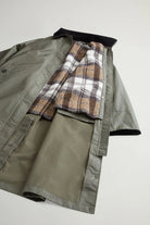 Waxed Coat Waxed Dark Green Coat showing the reversible inner vest with plaid pattern inside.