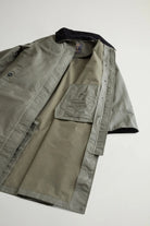 Waxed Coat Waxed Dark Green Coat displayed with open interior featuring a contrasting velvet collar and side pockets.