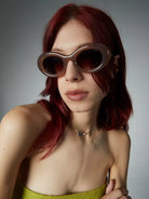 Woman wearing Molly Sahara Sunglasses with gradient brown lenses and eco-friendly frame.